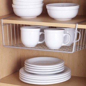 Under-shelf baskets are a great way to harness vertical space and add more storage. (Photo via ApartmentTherapy.com)