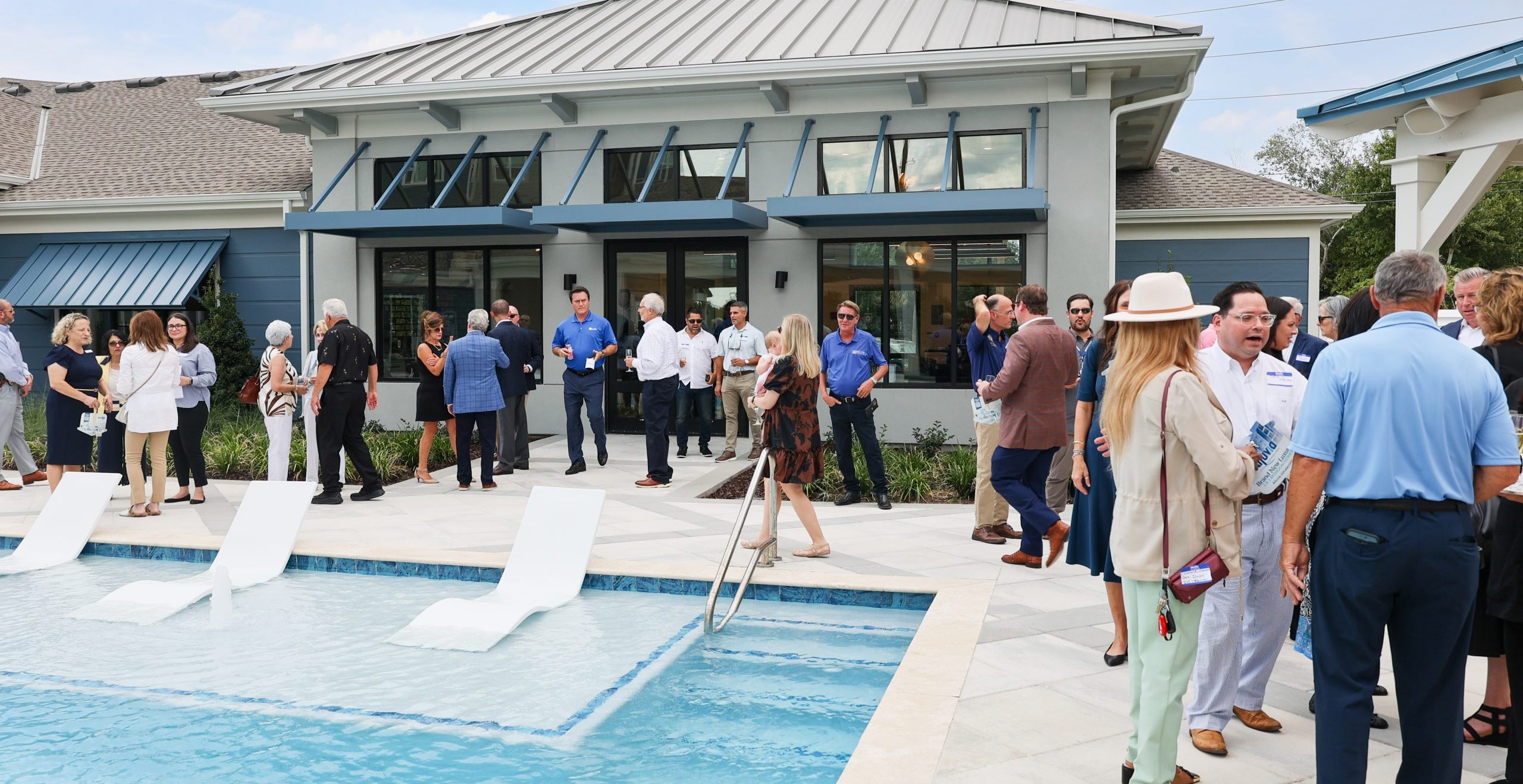Guests mingle poolside at Alluvia Grand Opening